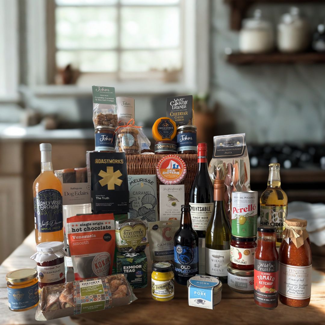 Johns Deluxe Deli Hamper featuring hand picked deli favourites including Perello Olives, Sea sisters tinned fish, tenuta marmorella pasta sauce, roastworks coffee, godminster cheddar truckles, exmoor tea, sams cider and much more