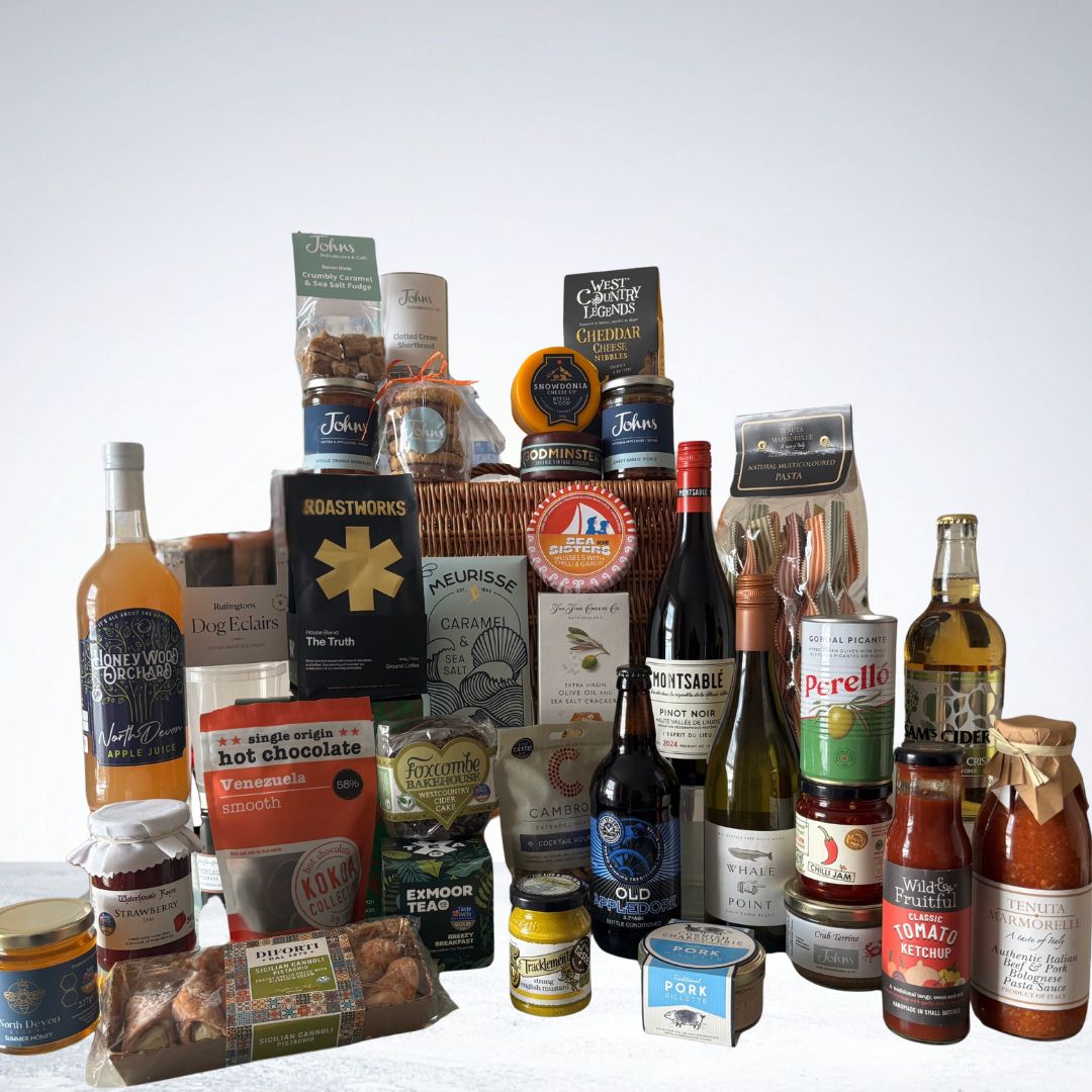 Johns Deluxe Deli Hamper filled with hand-picked gourmet favourites, including Perelló olives, Sea Sisters tinned fish, Tenuta Marmorella pasta sauce, Roastworks coffee, Godminster cheddar truckles, Exmoor Tea, Sam’s cider and more.