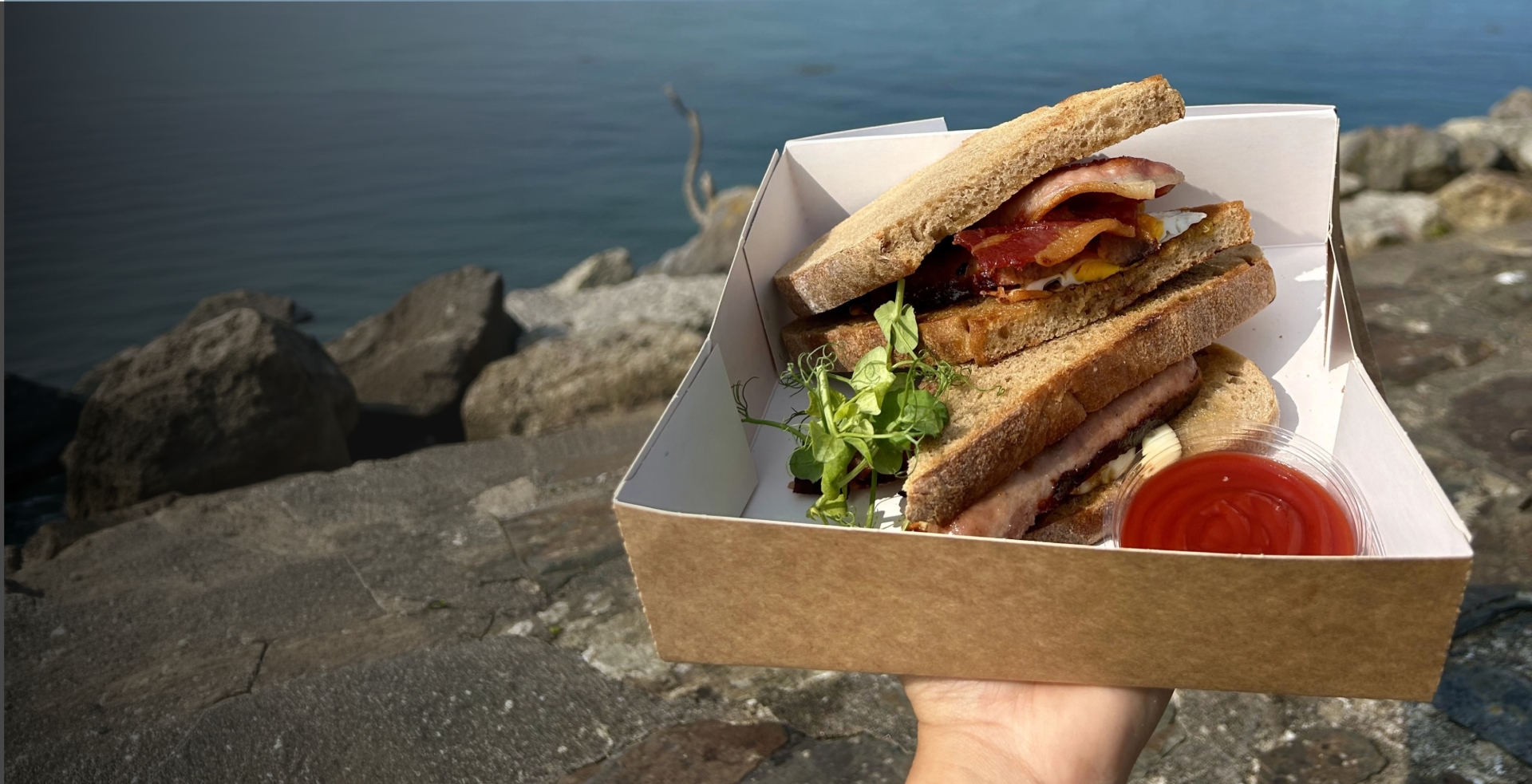 a person holding a takeaway