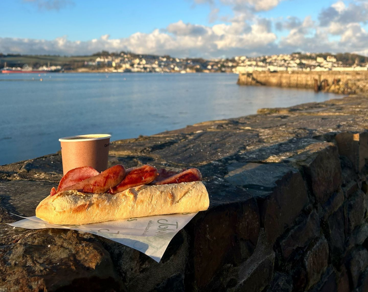 Crusty baguette filled with bacon & sausage, enjoy al fresco in the fresh air